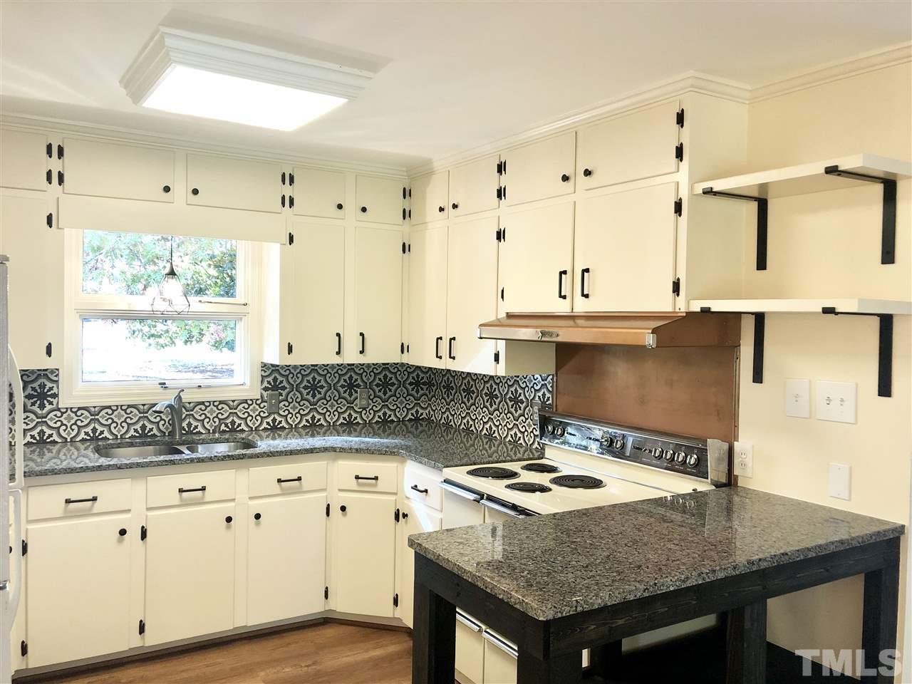 521 Buck Jones Road Raleigh, NC 27606 - Photo 10 of 30 a kitchen with stainless steel appliances granite countertop a stove a sink and a refrigerator