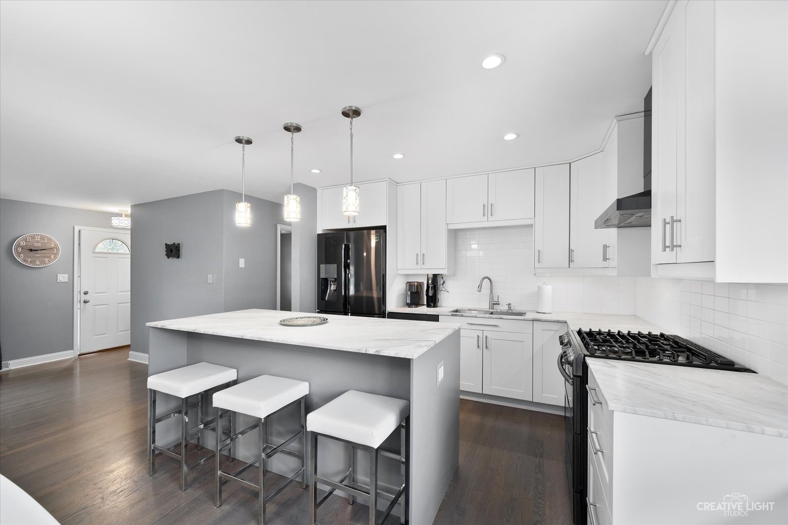 650 West Ronald Drive Addison, IL 60101 - Photo 5 of 14 a kitchen with a dining table chairs refrigerator and cabinets