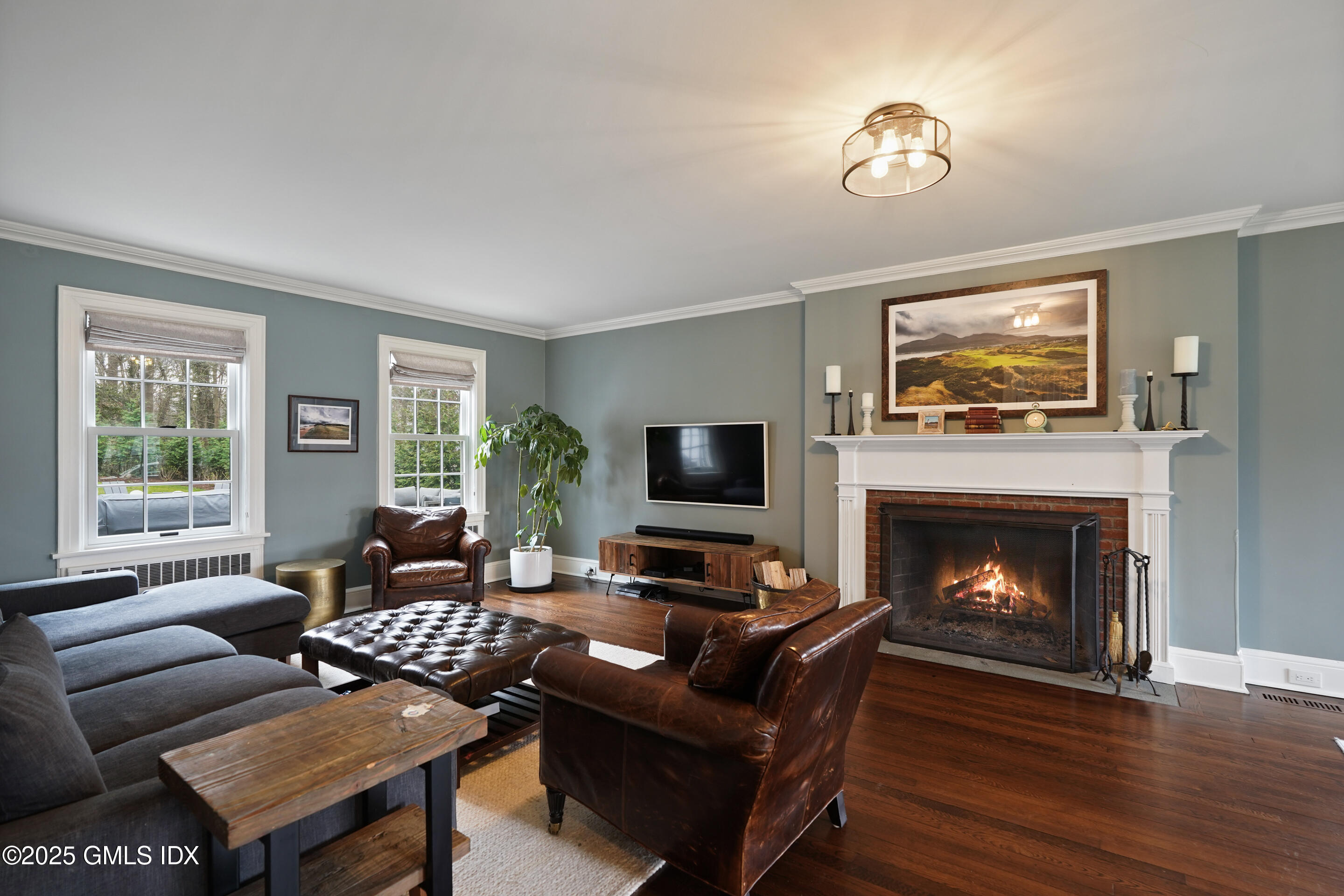 15 Anderson Road Greenwich, CT 06830 - Photo 3 of 7 a living room with furniture a fireplace and a flat screen tv