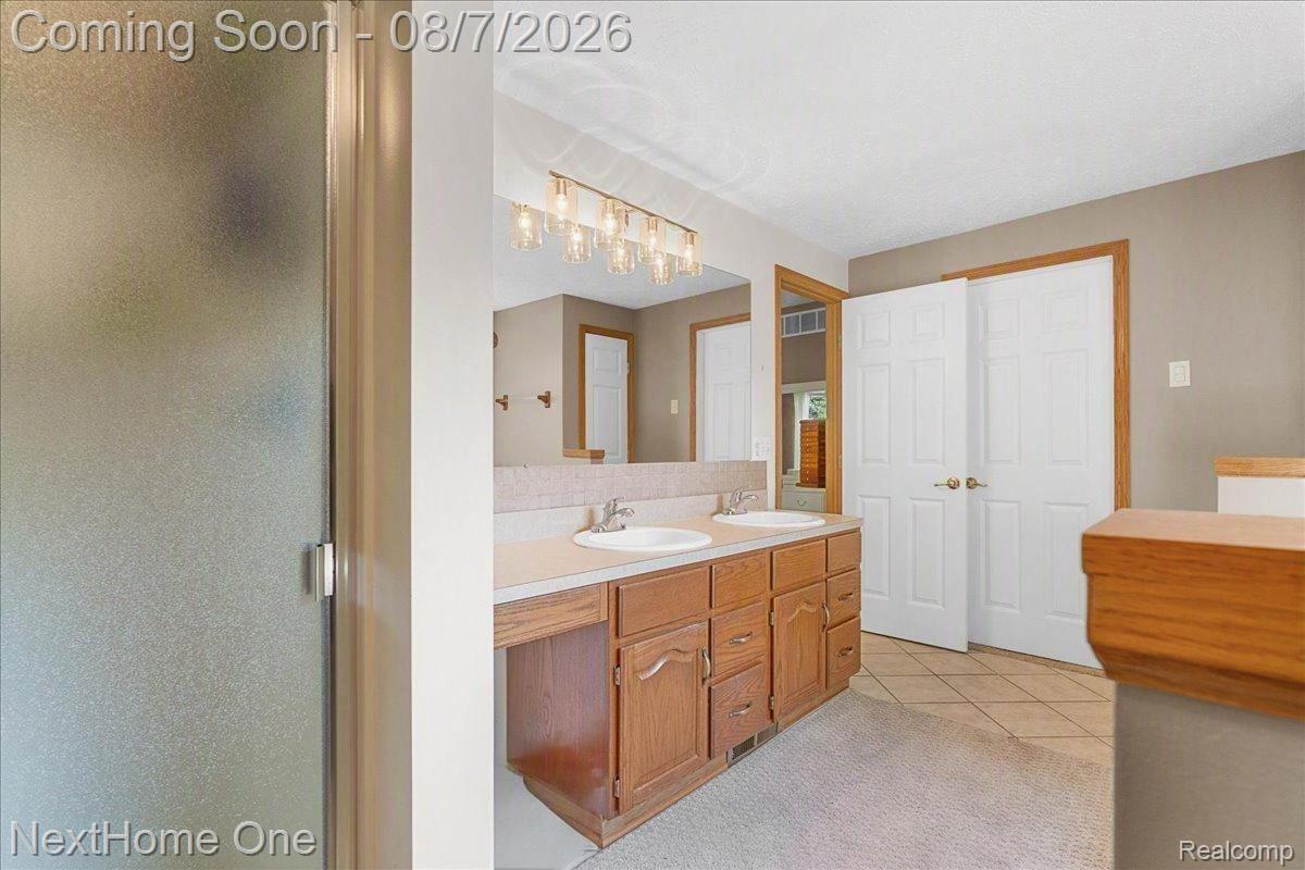 6260 Faussett Road Howell, MI 48855 - Photo 16 of 44 Primary bathroom with separate shower, tile floor, and walk-in closet
