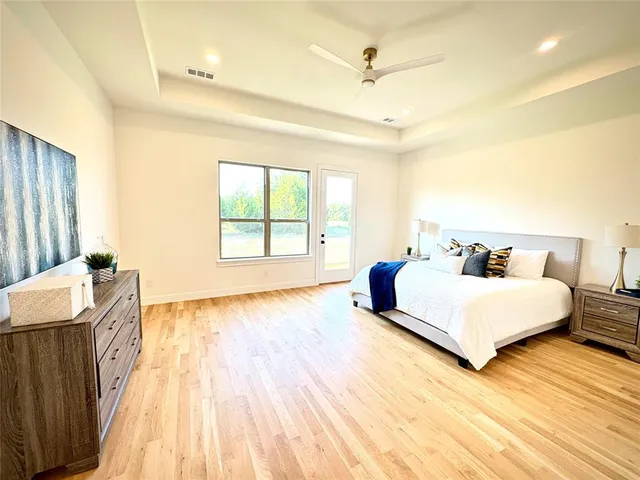 a bathroom with a double vanity sink a toilet a mirror and shower