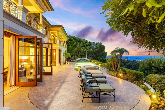 a lobby with furniture and chandelier