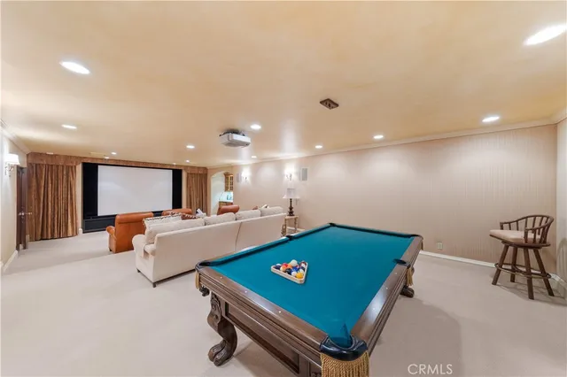 a living room with furniture a fireplace and kitchen view