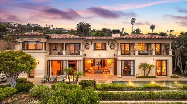 a front view of a house with a yard table and chairs