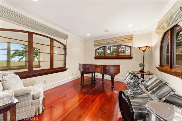 a living room with furniture a large window and a flat screen tv
