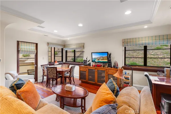 a bedroom with bed and glass window