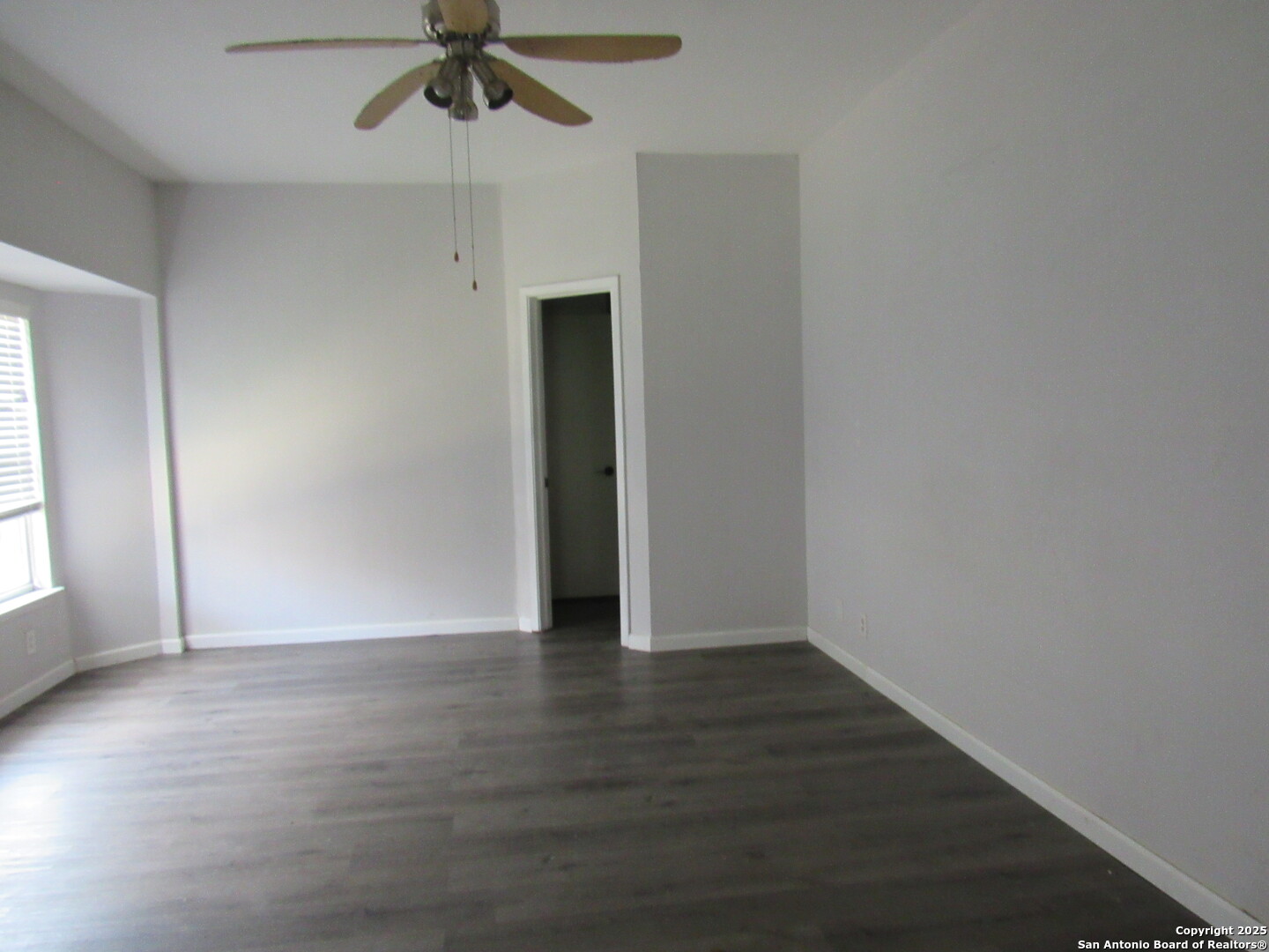 7731 Clear Ridge Drive San Antonio, TX 78239 - Photo 15 of 54 an empty room with wooden floor fan and windows
