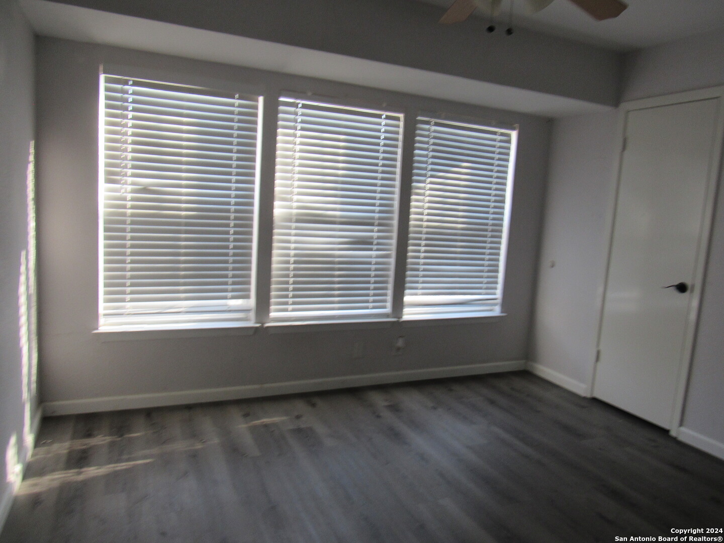 7731 Clear Ridge Drive San Antonio, TX 78239 - Photo 17 of 54 a view of an empty room with wooden floor and a window