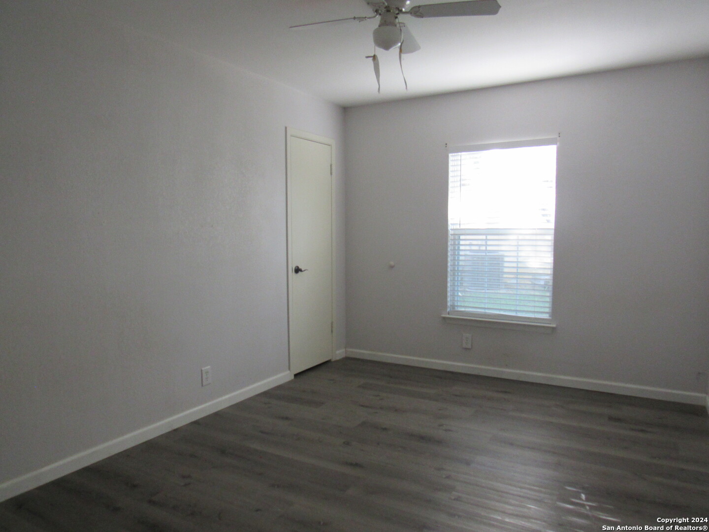 7731 Clear Ridge Drive San Antonio, TX 78239 - Photo 18 of 54 an empty room with wooden floor and windows