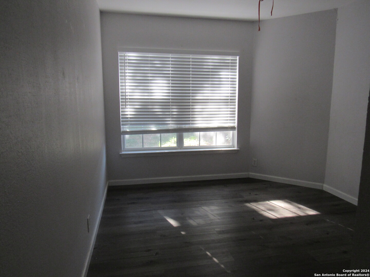 7731 Clear Ridge Drive San Antonio, TX 78239 - Photo 20 of 54 an empty room with wooden floor and a window