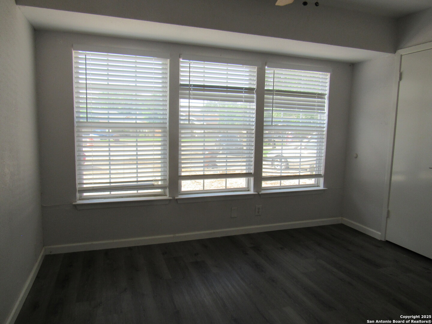 7731 Clear Ridge Drive San Antonio, TX 78239 - Photo 25 of 54 a view of an empty room with wooden floor and a window