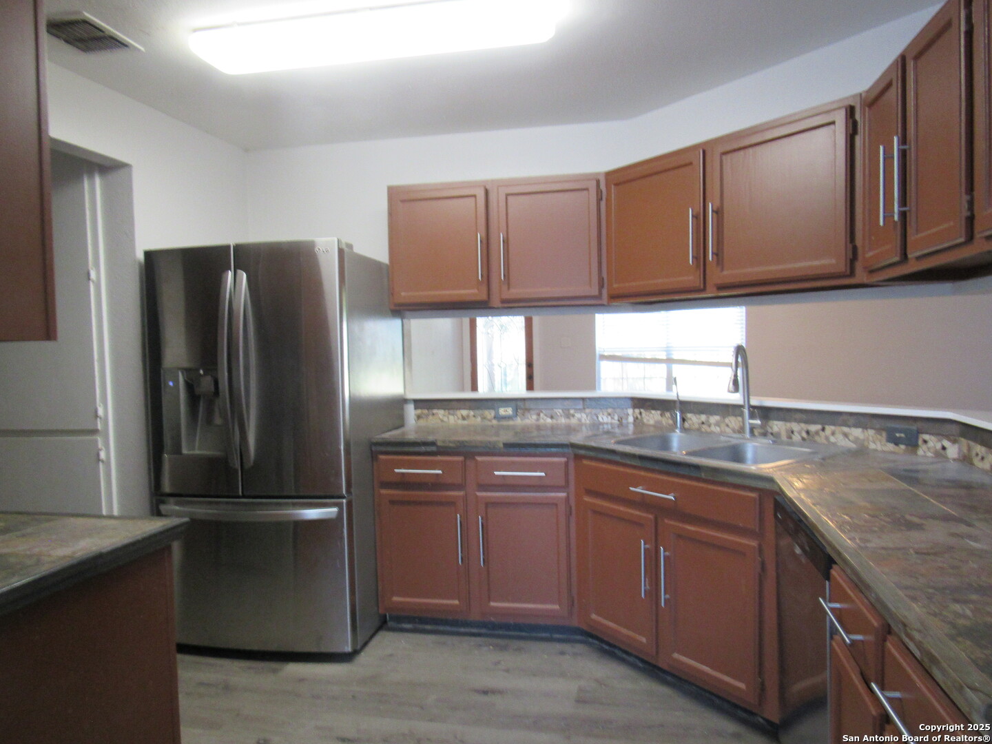 7731 Clear Ridge Drive San Antonio, TX 78239 - Photo 31 of 54 a kitchen with a sink and a refrigerator