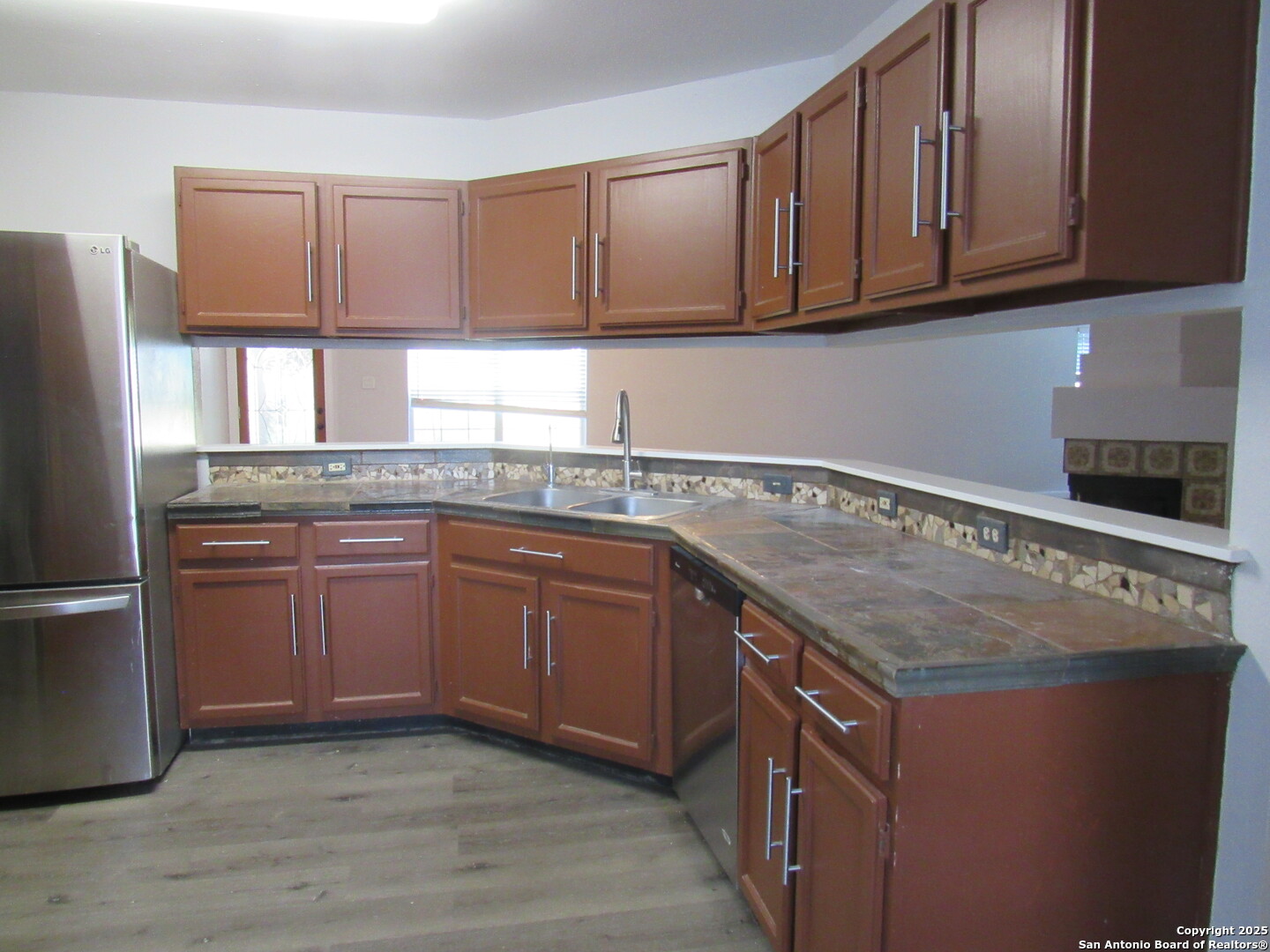 7731 Clear Ridge Drive San Antonio, TX 78239 - Photo 33 of 54 a kitchen with granite countertop a sink stove and cabinets