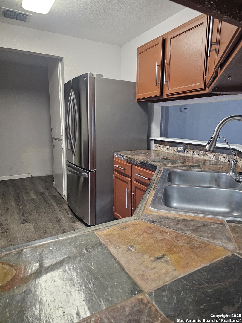 7731 Clear Ridge Drive San Antonio, TX 78239 - Photo 35 of 54 a kitchen with stainless steel appliances granite countertop a refrigerator and a sink