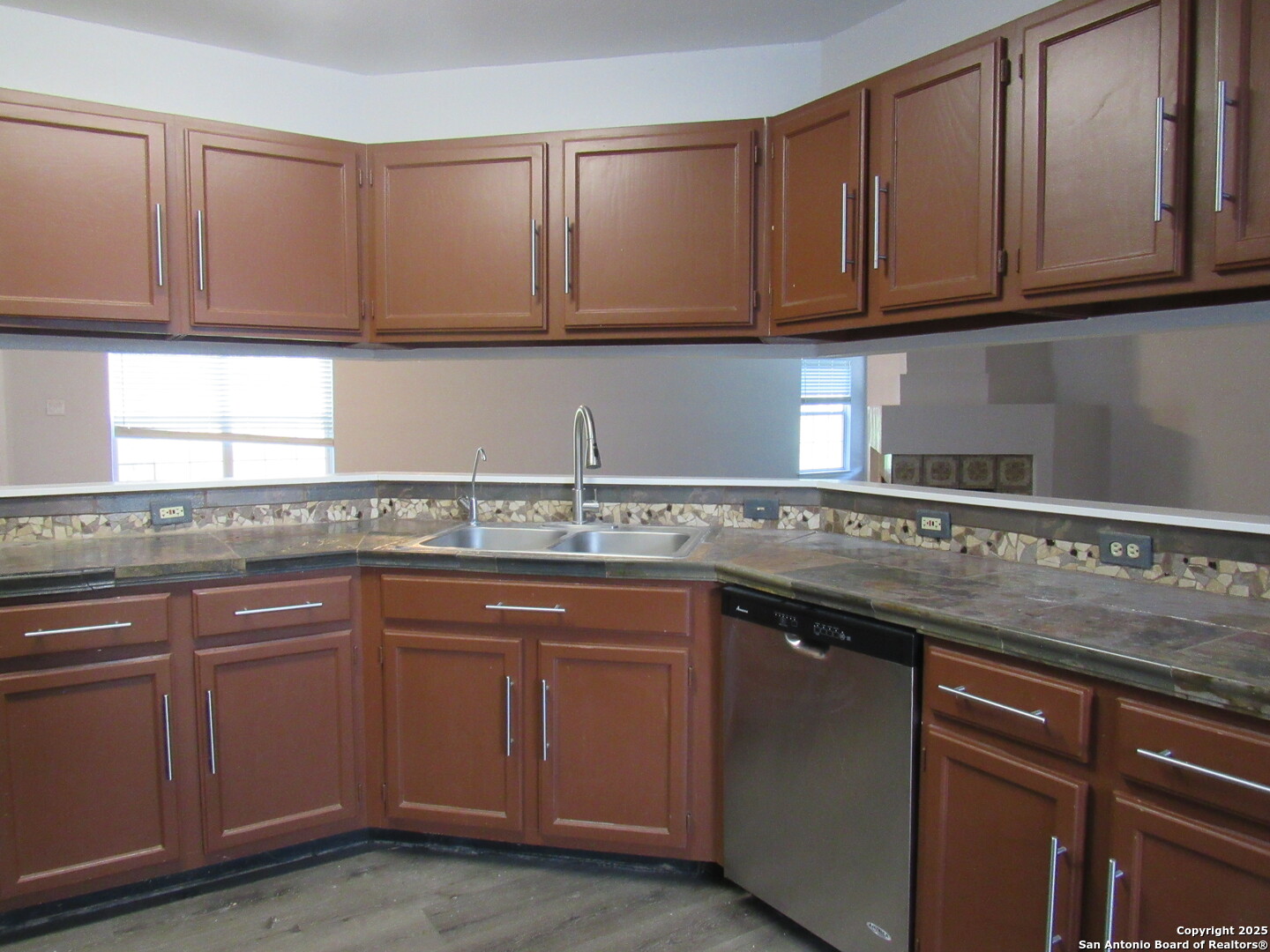 7731 Clear Ridge Drive San Antonio, TX 78239 - Photo 36 of 54 a kitchen with stainless steel appliances granite countertop a sink and cabinets