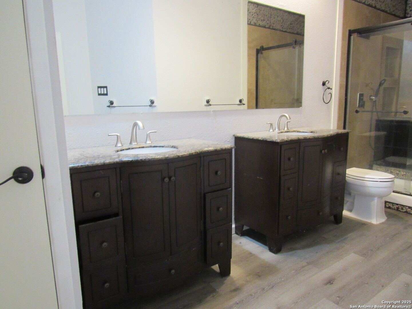 7731 Clear Ridge Drive San Antonio, TX 78239 - Photo 41 of 54 a bathroom with a double vanity sink toilet and mirror
