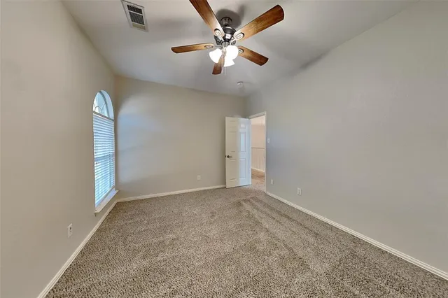 a spacious bathroom with a granite countertop sink mirror and toilet