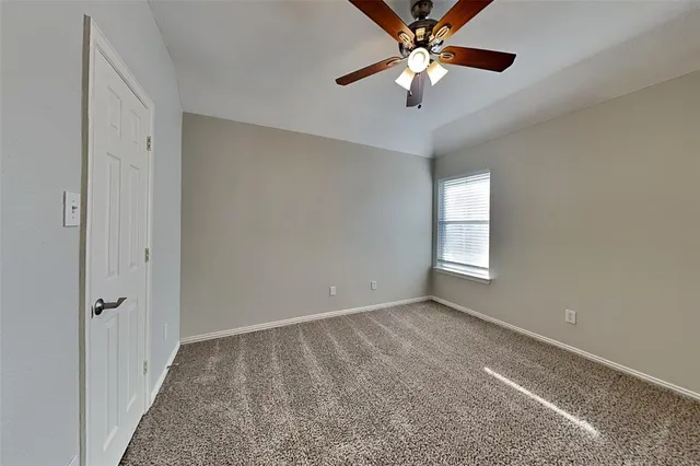 a view of a livingroom with a ceiling fan and window