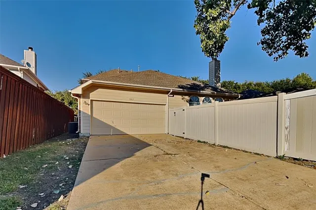 a view of an empty room with a chandelier fan