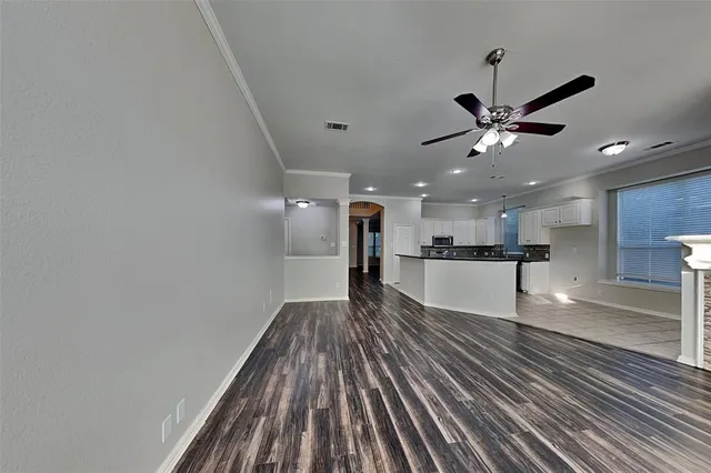 a view of a kitchen with a sink and a refrigerator