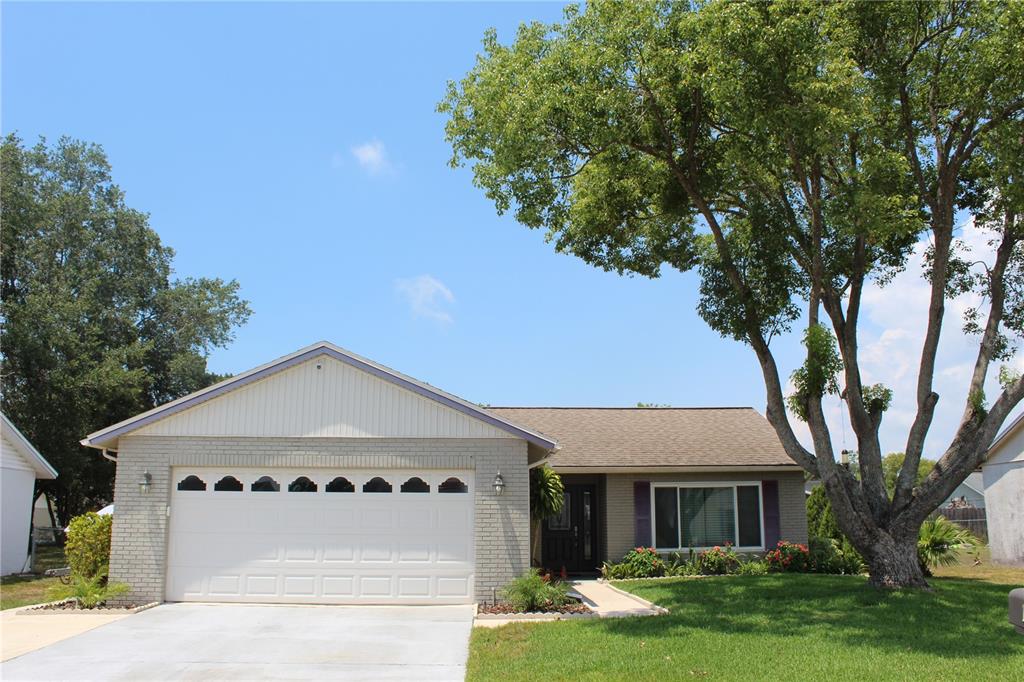 7974 Griswold Loop New Port Richey, FL 34655 - Photo 1 of 1 front view of house with a yard