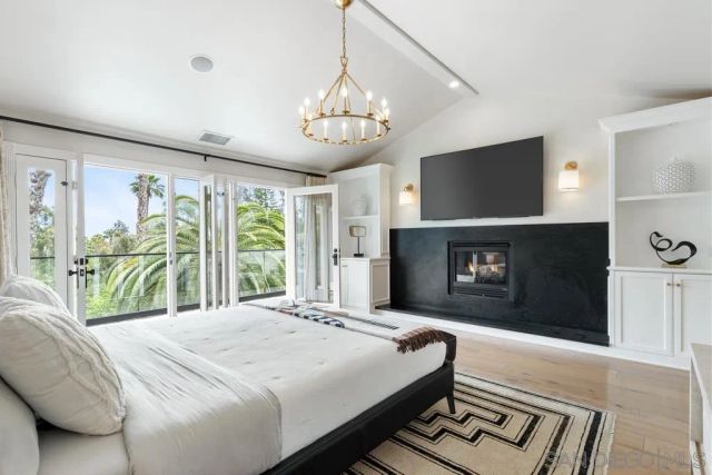 a bedroom with a bed and a fireplace