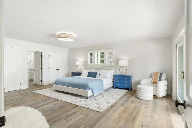 a bedroom with a bed and large window