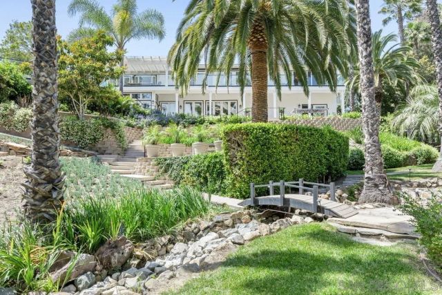 a view of backyard with swimming pool and furniture
