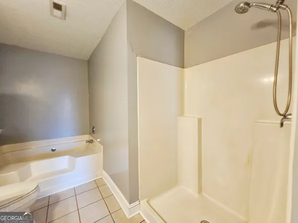 a bathroom with a bathtub and shower