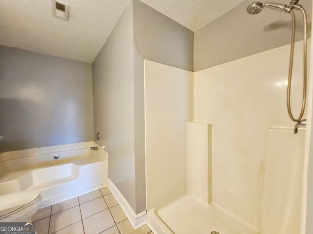 a bathroom with a bathtub and shower
