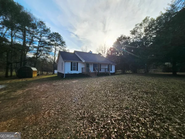 a view of house with a yard