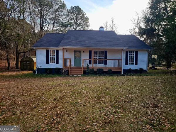 a front view of a house with a garden and deck