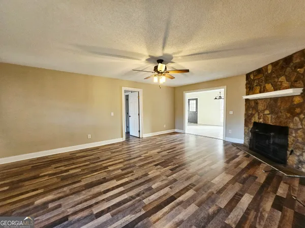 wooden floor in an empty room with a fireplace