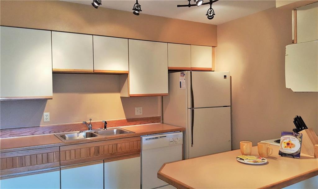 875 4 O Clock Road, Unit D1 Breckenridge, CO 80424 - Photo 11 of 25 a kitchen with a sink a refrigerator and cabinets