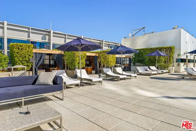 a view of patio with a table and chairs under an umbrella