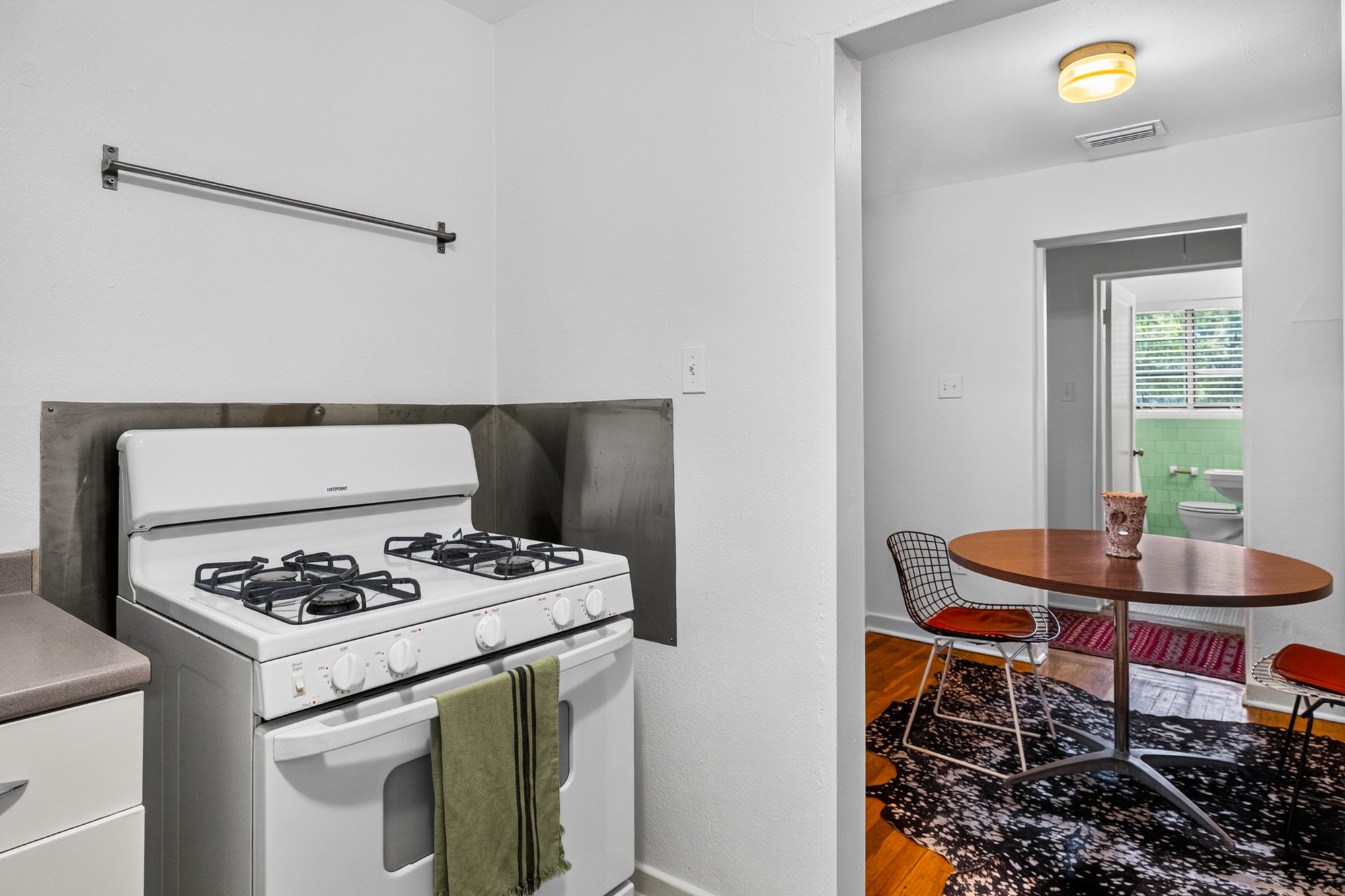 1302 Kirkwood Road, Unit B Austin, TX 78722 - Photo 7 of 21 A compact kitchen offers a gas range for convenient meal preparation.
