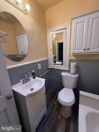 a bathroom with a toilet sink and mirror