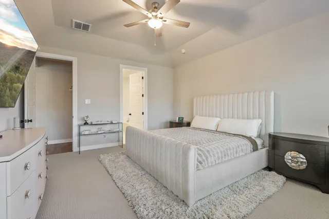 a bedroom with a bed and a chandelier