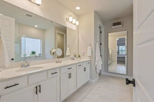 a bathroom with a granite countertop sink mirror and double