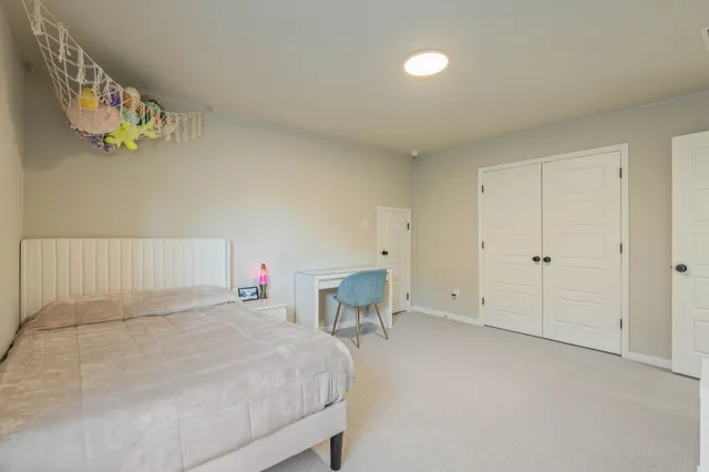 a bedroom with a bed and a table