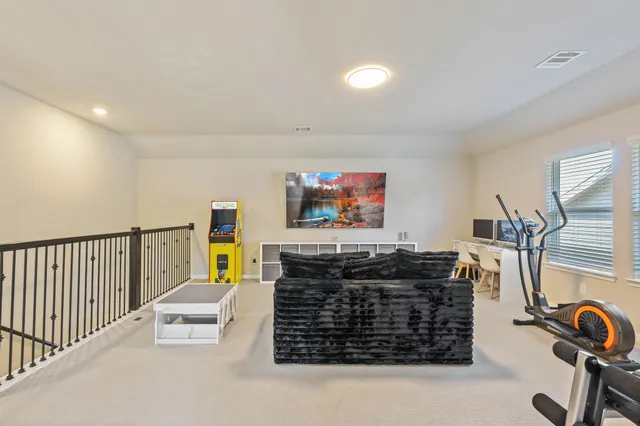 a living room with furniture a flat screen tv and a couch