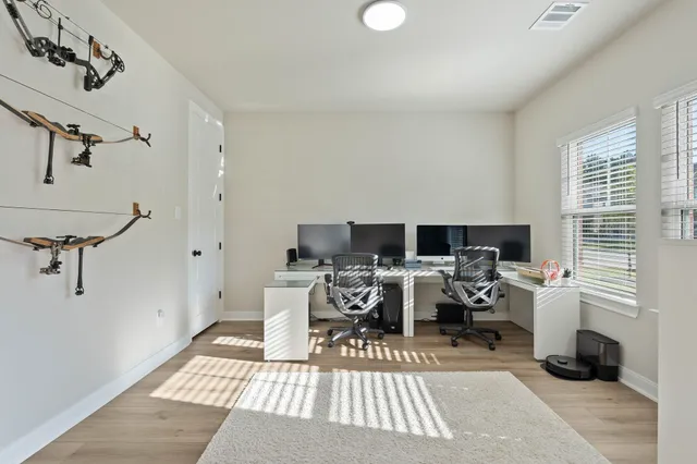 a living room with furniture a rug and a white floor