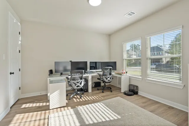 a living room with furniture a flat screen tv and a window