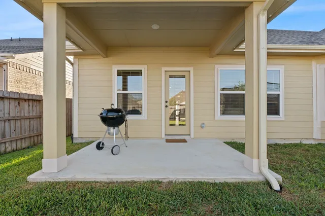 a view of a porch with furniture and a yard