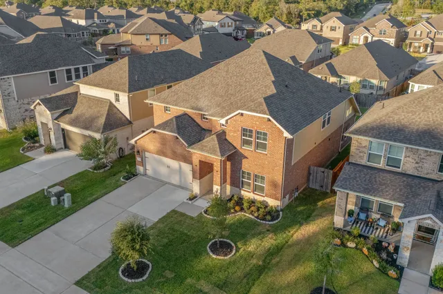 an aerial view of a house with yard swimming pool and outdoor seating