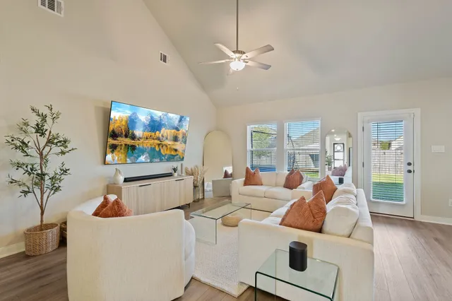 a living room with furniture and a flat screen tv