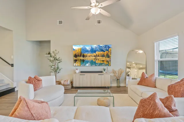 a living room with furniture and a large window