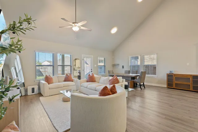 a living room with furniture and a floor to ceiling window