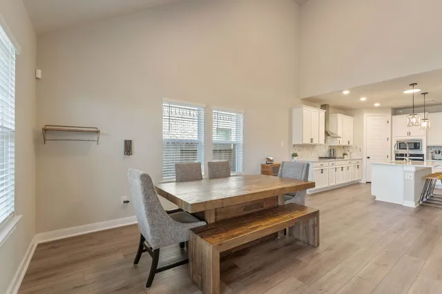 a outdoor dining space with furniture and wooden floor