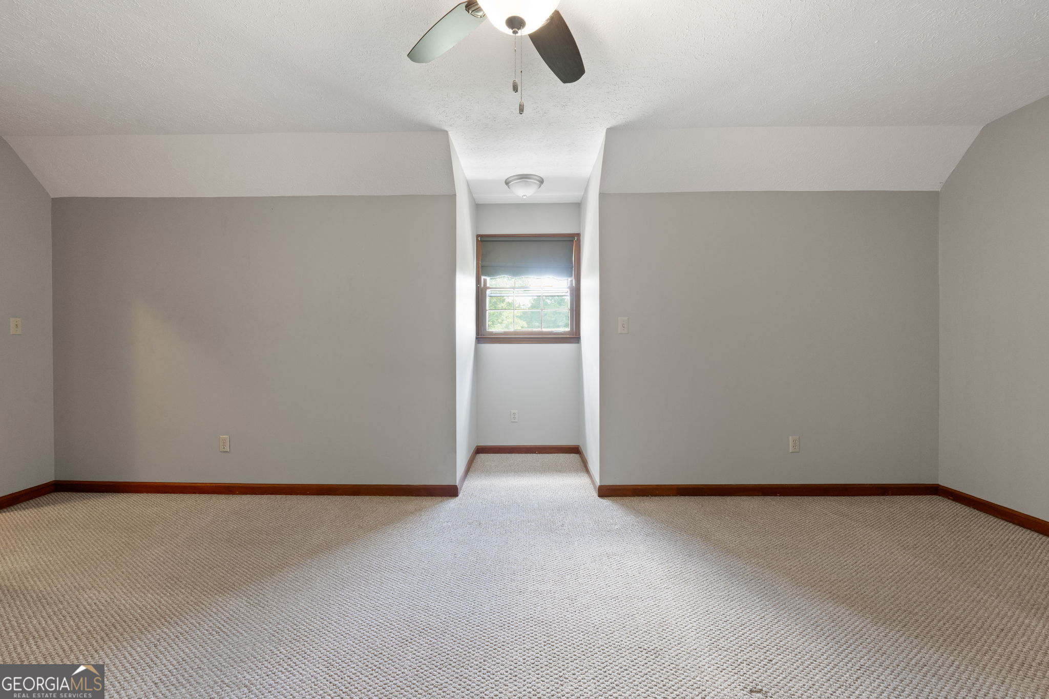 2050 North McDonough Road Griffin, GA 30223 - Photo 20 of 42 an empty room with a ceiling fan and window